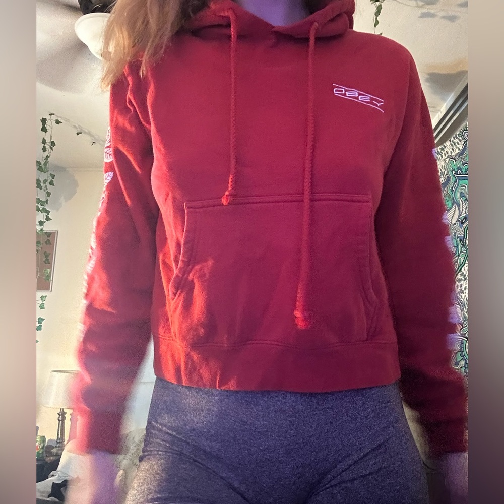Red obey hoodie, with flowers on the sleeves, 2 draw strings in the front